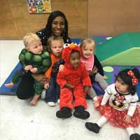 Woman with children in Halloween costumes